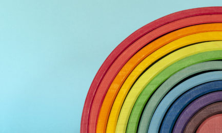 wooden blocks form a rainbow on a back background