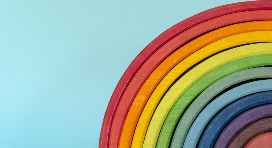 wooden blocks form a rainbow on a back background