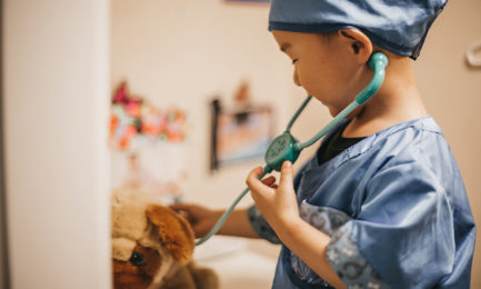 Toddler engages in dramatic play as a veterinarian, supporting his social emotional development